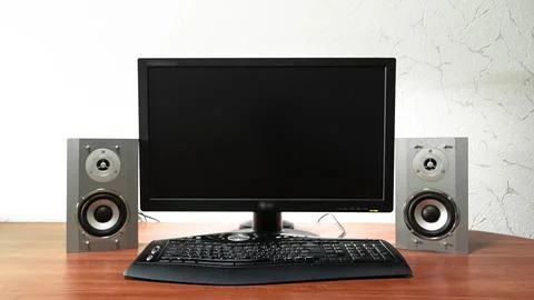 Work desk for digital job with computer, audio speakers and keyboard timela.. 库存照片