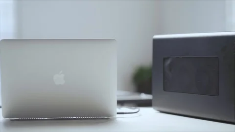 Work desk with a laptop and an external gpu. Stock Footage 129726635