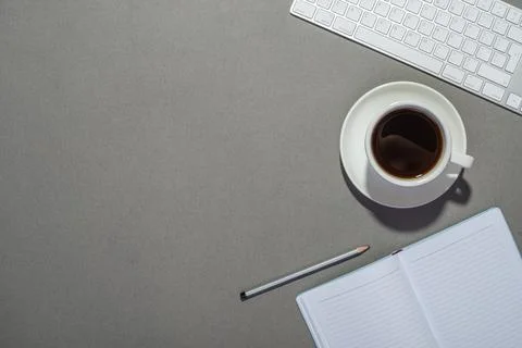 Work desk with notepad, keyboard and coffee Stock Photos