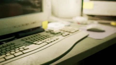 Work desk with old computer and keyboard cluttered with notes and items Stock Illustration