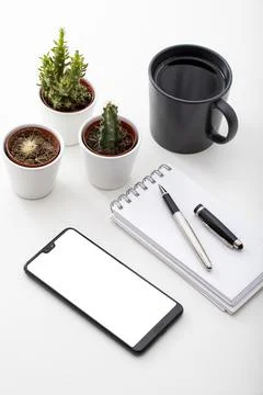 Work desk. With smartphone, Coffee, tiny cactus and notepad Stock Photos