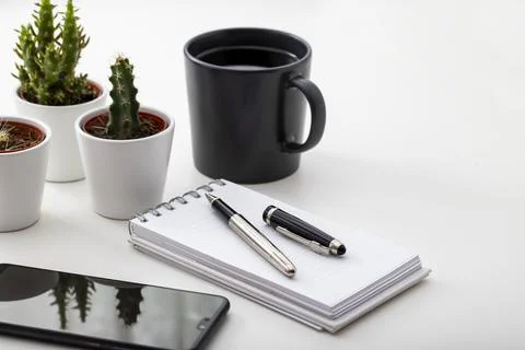 Work desk. With smartphone, Coffee, tiny cactus and notepad Stock Photos