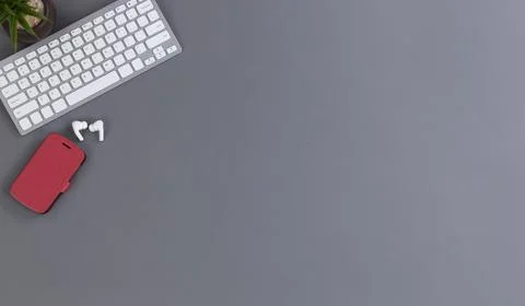 Work desktop with wireless devices and a baby plant decoration Stock Photos