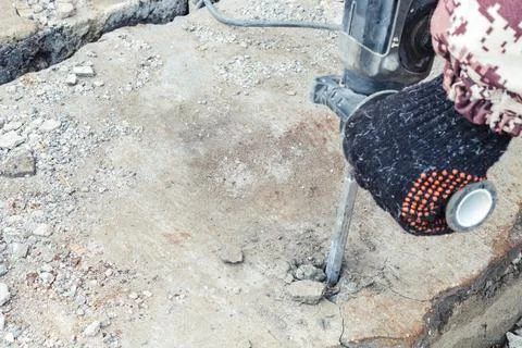 Work on the destruction of brickwork with a perforator in the open air. Stock Photos