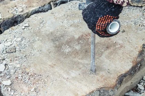 Work on the destruction of brickwork with a perforator in the open air. Stock Photos