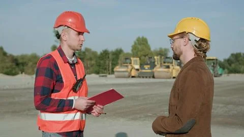 Work discussion with builder at construction site Stock Photos