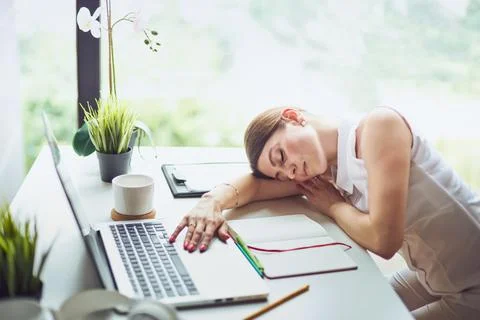 Work is done coffee break. Overworked and tired young business woman sleeping Stock Photos