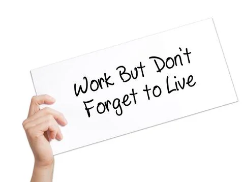 Work But Don't Forget to Live  Sign on white paper. Man Hand Holding Paper wi Stock-Fotos