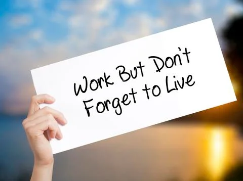 Work But Don't Forget to Live  Sign on white paper. Man Hand Holding Paper wi Stock-Fotos