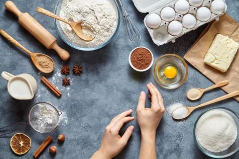 Work with the dough. The kitchen table raw ingredients, the woman's hand ready Stock Photos