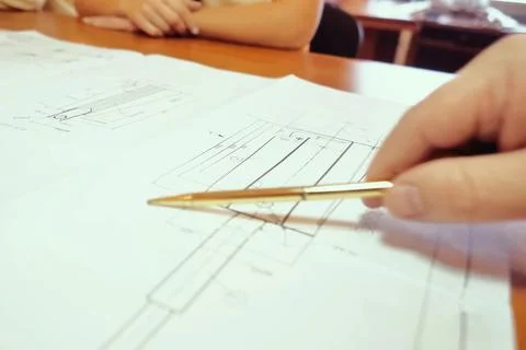 Work on a drawing of diagram by an engineer. Engineer's hand over the drawing Stock Photos