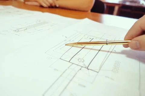 Work on a drawing of diagram by an engineer. Engineer's hand over the drawing Stock Photos