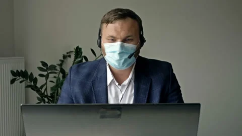 Work during the coronavirus epidemic. Middle aged businessman in protective Stock Footage 137864500