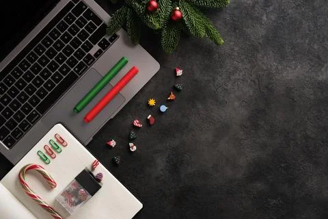 Work during the holidays. Notebook, notepad, colorful sticky notes, candy can Stock Photos