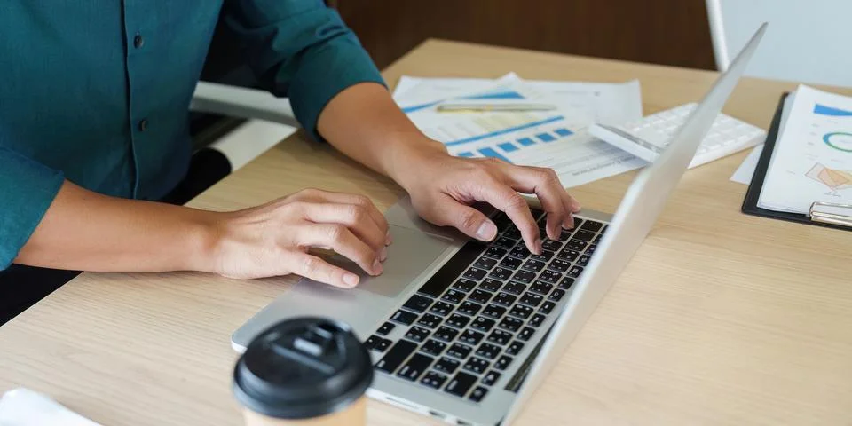 Work Efficiency and Digital Productivity. A professional typing on a laptop with Stock Photos