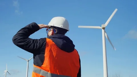 Work examines the windmills is adjusting his helmet Stock Footage 72112666