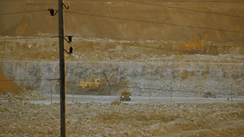 Work of excavator and heavy mining truck in limestone quarry Stock Footage 106582093