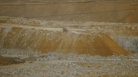 Work of excavator and heavy mining truck in limestone quarry Stock Footage 106582140