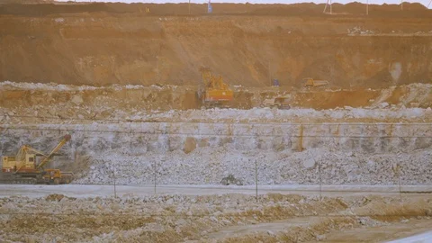 Work of excavator and heavy mining truck in limestone quarry Stock Footage 106582290
