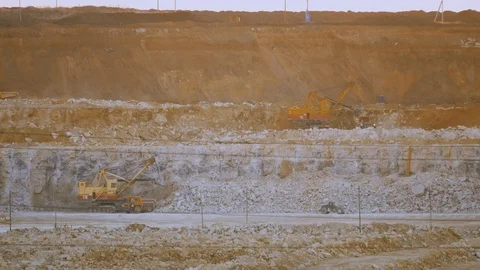 Work of excavator and heavy mining truck in limestone quarry Stock Footage 106582314