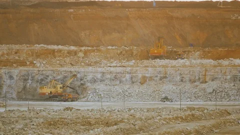 Work of excavator and heavy mining truck in limestone quarry Stock Footage 106582457
