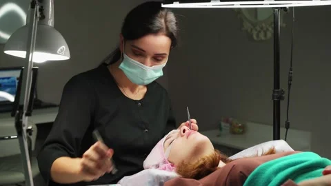 The work of an eyelash extension master. 4k Stock Footage 140712323