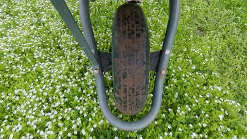 Work in the field concept. Close-up view of a wheelbarrow wheel plan, top vie Stock Footage 151683213