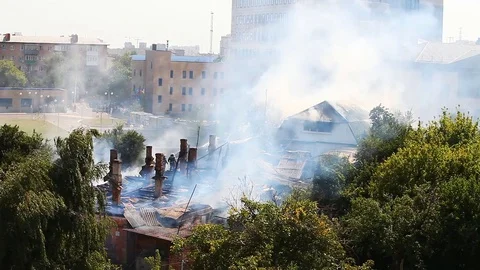 Work of firefighters at putting out the burning roof of the old house Stock Footage 79504658