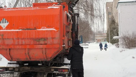 Work the garbage cars in winter. Garbage transport car loading itself. Stock Footage 87847117