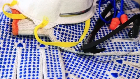 Work gloves with blue pimples, protective glasses, respirators and ear plugs Video stock 70826184