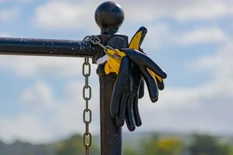 Work gloves left on a post	 Stock Photos