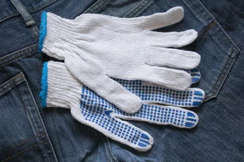 Work gloves white on a denim background Stock Photos