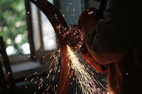Work with a grinder, preparing the metal for welding Stock Photos