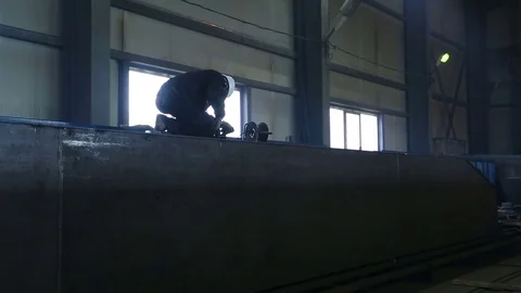 Work grinds after welding a huge metal parts Stock Footage 75464697