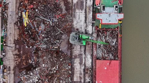 Work is happening at a shipyard with cargo being loaded onto a vessel Stock-Footage 337941771