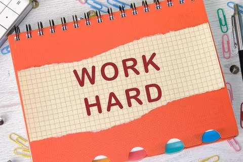 Work Hard written on a piece of a sheet in a cage on the background of a no.. Stock Photos