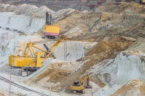 Work of heavy mining excavators in the chalky quarry Stock Photos