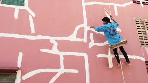 Work at height by Worker fixing cracks on wall, spreading plaster using trowel, Stock Footage 232218893