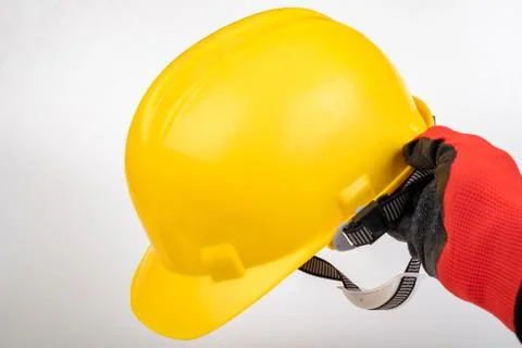 Work helmet held in hand. Work glove and cash registers. Stock Photos