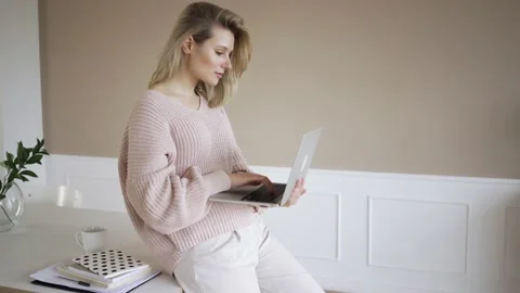 Work from home concept, Portrait of beautiful young woman working on laptop in Stock Footage 142210565