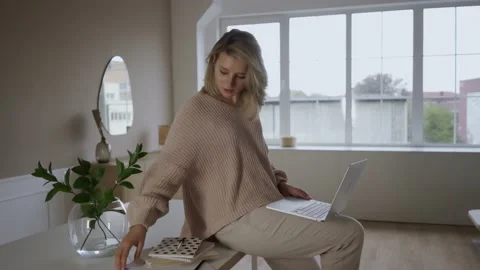 Work from home concept, Portrait of beautiful young woman working on laptop in Stock Footage 142210779