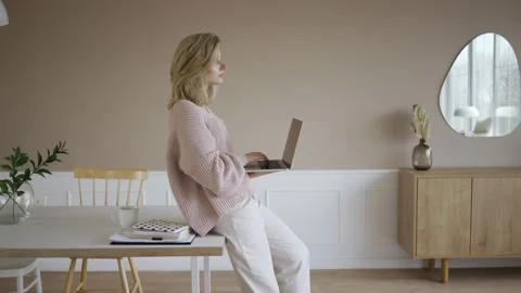 Work from home concept, Portrait of beautiful young woman working on laptop in Stock Footage 142210845