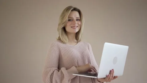 Work from home concept, Portrait of beautiful young woman working on laptop in Stock Footage 142210962