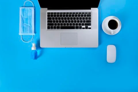 Work from home concept. Top view Laptop, black coffee. mouse, medical face ma Stock Photos