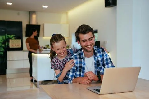 Work from home. Daughter interrupting her father while he is having a business Stock Photos