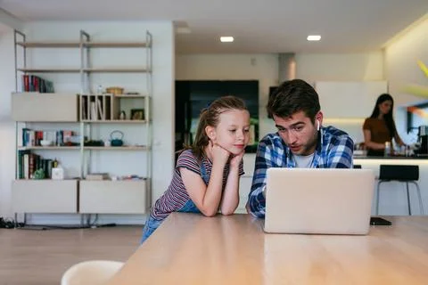 Work from home. Daughter interrupting her father while he is having a business Stock Photos