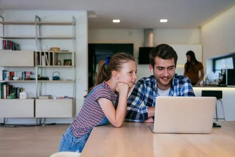 Work from home. Daughter interrupting her father while he is having a business Stock Photos