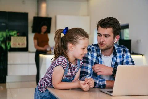 Work from home. Daughter interrupting her father while he is having a business Stock Photos