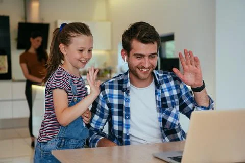 Work from home. Daughter interrupting her father while he is having a business Stock Photos