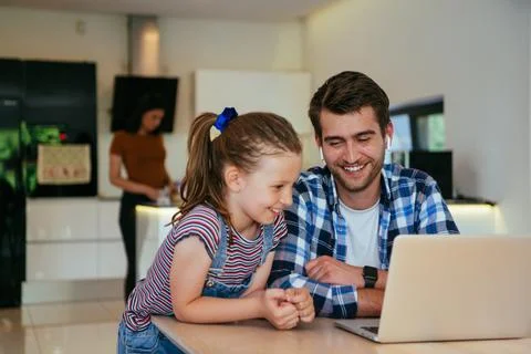 Work from home. Daughter interrupting her father while he is having a business Stock Photos